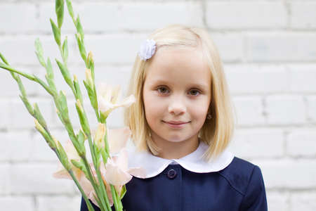Smiling child girl with flowersの写真素材