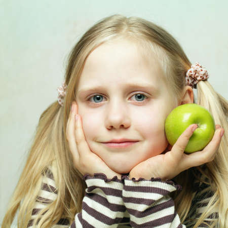 Smiling child and appleの写真素材