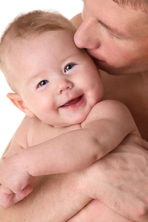 Father kissing smiling baby - parental loveの写真素材