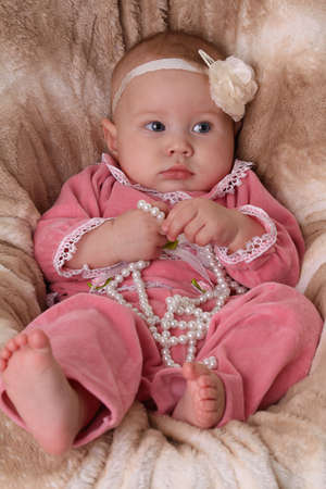 Cute baby girl in a pink dressの写真素材