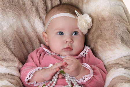 Beautiful pensive baby girlの写真素材
