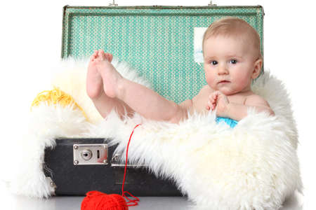 Little baby in vintage suitcase isolated on whiteの写真素材