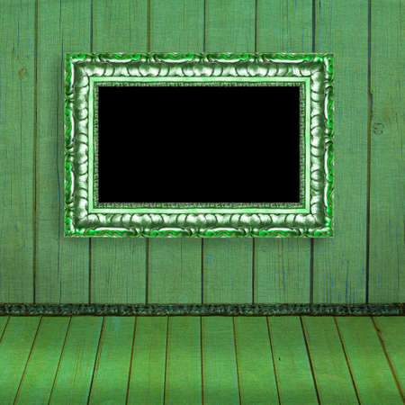 Photo frame hanging on the green blurred wall - old album background