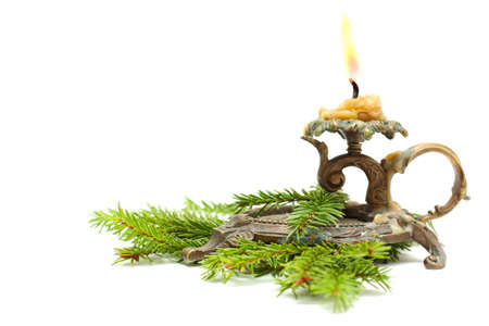 Old candlestick with Christmas fir branchの写真素材