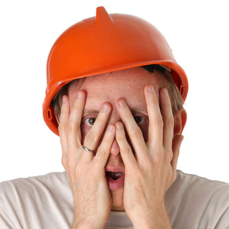 Shocked and surprised builder craftsman isolated on a white backgroundの写真素材