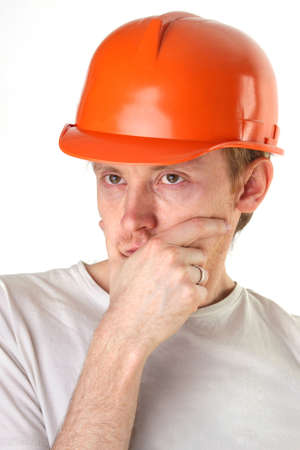 brooding architect engineer in orange construction helmetの写真素材