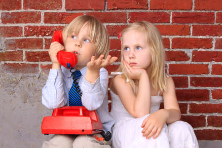 Girl and boy with the phone. Relationship and communicationの写真素材