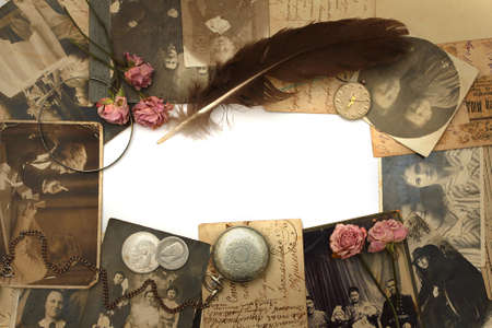 Vintage background with old watch, postcards, photographs and flowersの写真素材