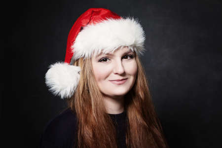 Christmas Woman in Santa Hat on Blackboard Backgroundの写真素材