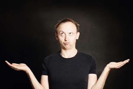 Man Thinking and showing his empty hands. Choice conceptの写真素材