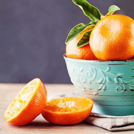 Juicy Mandarin Fruit in a Bowl on Backgroundの写真素材