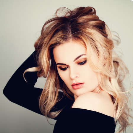 Gorgeous Woman with Blonde Hair. Blonde Curly Hairstyleの写真素材