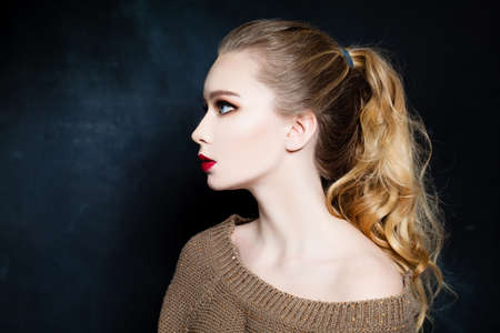 Pretty Woman with Blonde Curly Hair on Blackboard Background