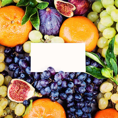 Fruit Background with Blank Business Card, Grape, Figs, Plum and Tangerines Fruits. Diet and Healthy Eating Conceptの写真素材