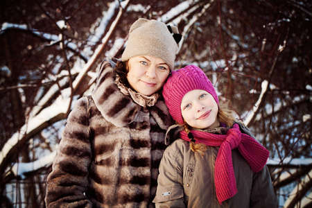 Smiling Daughter and Mother in Winter Parkの写真素材