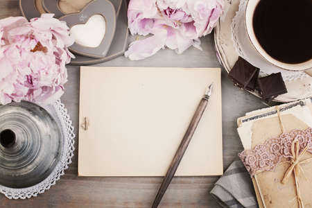Vintage Frame with Black Coffee, Flower, Pen and Old Paper Backgroundの写真素材