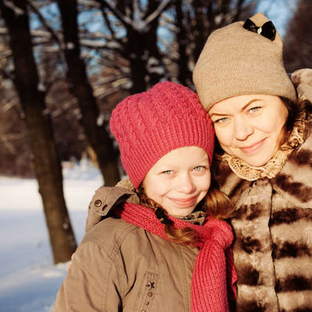 Mother and Daughter in Sunny Winter Day Outdoorsの写真素材