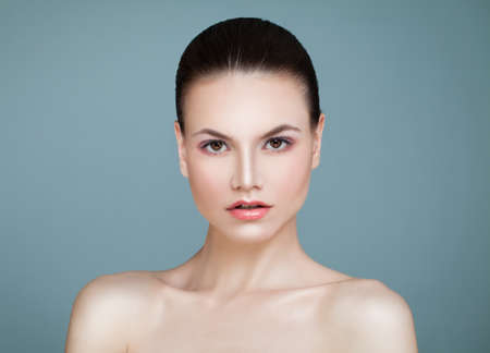 Spa Beauty. Young Woman with Healthy Skin on Blue Background. Aesthetic Medicine, Healthcare and Cosmetology Conceptの写真素材