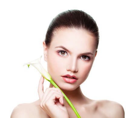 Beautiful Female Face. Spa Woman with Healthy Slin and White Flowerの写真素材
