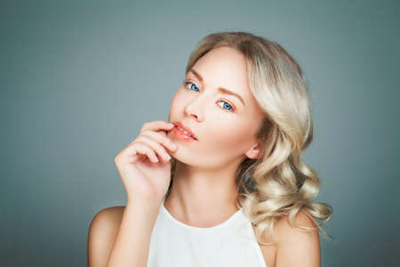 Smiling Woman Fashion Model with Blonde Curly Hairstyleの写真素材