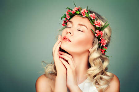 Relaxing Woman Spa Model with Flowers on Green Backgroundの写真素材