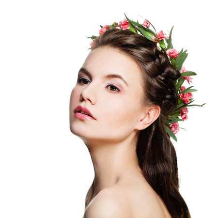 Spa Model Woman with Healthy Skin, Nude Makeup and Flowers Isolated on White Backgroundの写真素材
