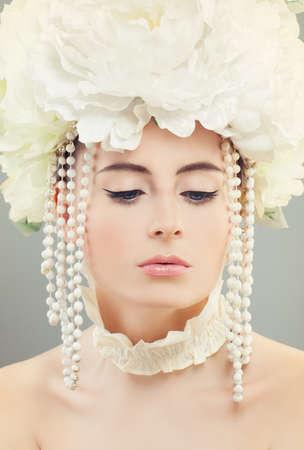Perfect Woman Fashion Model with Makeup and White Flowers Wreath. Beautiful Girl with Flowers Hairstyle and Make upの写真素材