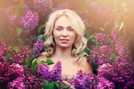 Perfect Woman Model with Blonde Flowers and Fresh Skin Outdoorsの写真素材