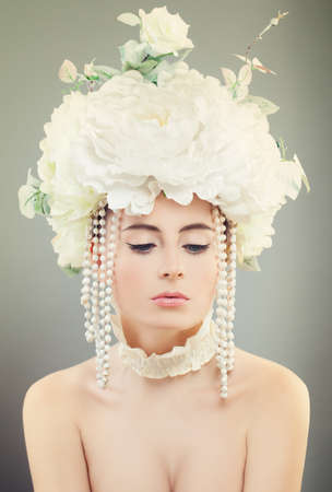 Pretty Girl with White Rose Flowers, Makeup and Clear Skin. Beauty, Facial Treatment and Cosmetologyの写真素材