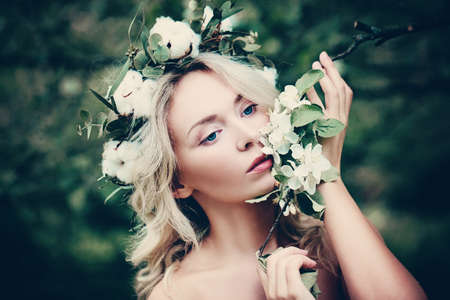 Cute Woman Spa Model with White Spring Flowers Outdoorsの写真素材