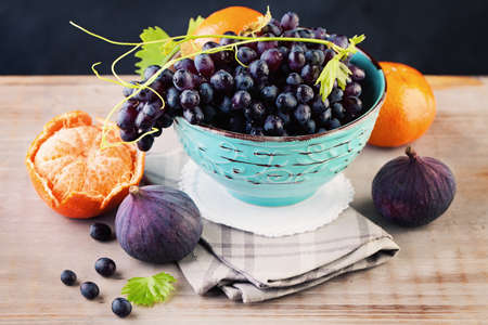 Fruit on Wooden Board. Fresh Grape, Mandarin and Figsの写真素材
