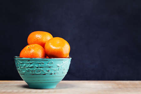Tangerines Fruit on Old Wooden Board Backgroundの写真素材