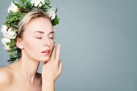 Spa Woman with Green Leaves and Cotton Flowers Wreath. Beautiful Spa Modelの写真素材