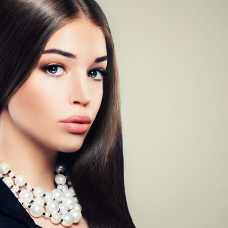 Beautiful Young Woman Fashion Model with Makeup and Pearls Necklacesの写真素材
