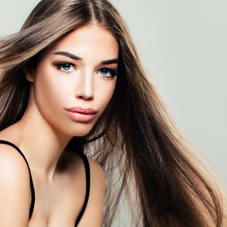 Young Cute Woman with Long Healthy Hair. Pretty Face, Makeup, Hairstyleの写真素材
