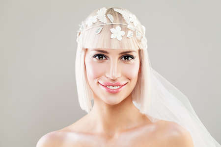 Happy Bride Woman. Beautiful Blonde Fashion Model with Bob Hairstyle, Makeup and Veilの写真素材