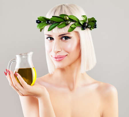 Beautiful Healthy Woman on Background with Copy Space. Cute Girl with Olive Oil, Diet and Healthy Eating Conceptの写真素材