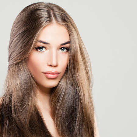 Beautiful Woman with Long Brown Hair. Makeup, Hairstyle and Cute Face. Fashion Portraitの写真素材