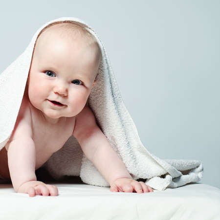 Cheerful Baby with White Towel. Happy Little Child, 6 month oldの写真素材