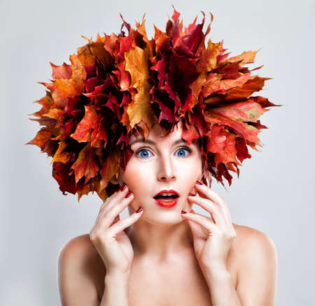 Surprised Woman Fashion Model with Fall Leaves Wreath, Autumn Portraitの写真素材