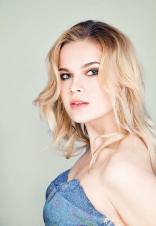 Fashion Portrait of Cute Blonde Woman with Wavy Hairの写真素材