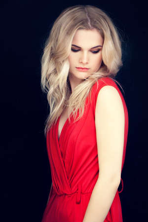 Pretty Blondie Woman Fashion Model with Blonde Hairstyle. Stylish Girl in Red Clothの写真素材