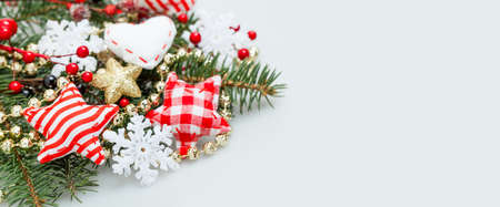 Christmas Banner Background with White Snowflake, Xmas Tree Twig, Red Stars, Holly Berries and New Year Decor on White Backgroundの写真素材