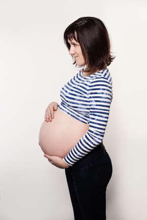 Pregnant Woman in Blue Cloth on Grey Background, Profileの写真素材