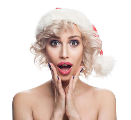 Christmas Woman in Santa Hat Isolated on White Background . Cute Surprised Woman with Opened Mouth. Christmas Conceptの写真素材