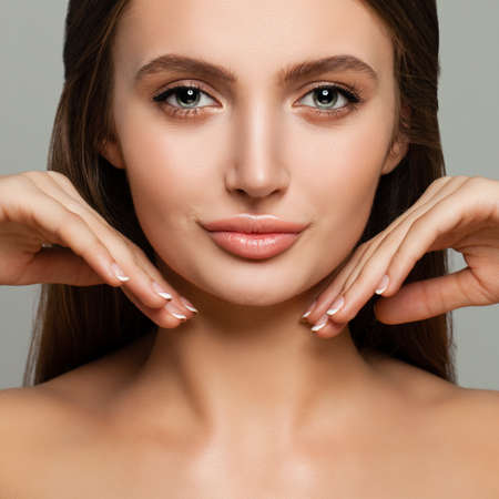 Young Female Face Closeup. Cute Model Woman with Healthy Skin and Manicureの写真素材