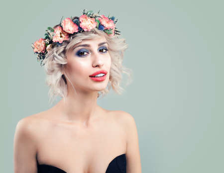 Spring Woman Fashion Model with Rose Flowers on her Head. Cute Girl with Blonde Bob Hairstyle and Makeupの写真素材