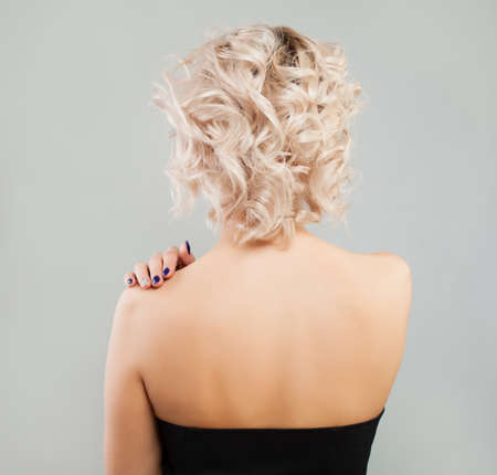 Female Back. Blonde Woman with Curly Bob Hairstyleの写真素材