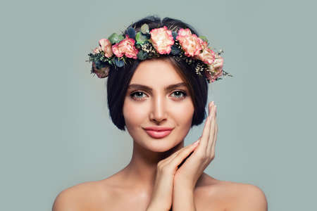 Young Healthy Woman with Flowers. Spa Model on Blue Banner Background. Skincare and Cosmetology Conceptの写真素材