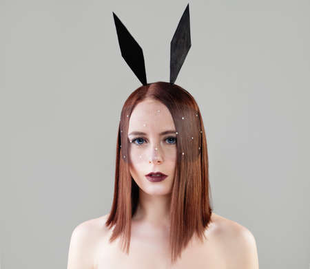 Glamorous Woman with Geometric Bob Hairstyle and Makeup. Sexy Fashion Model with Black Bunny Earsの写真素材